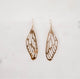 Hand crafted hammered dragonfly wing earrings on a white background by Krista Knickerbocker Designs.