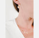 Close up of a woman's neck wearing sparkling, textured gold circle dangle earrings and a dainty 14k gold filled everyday chain both by Krista Knickerbocker Designs.
