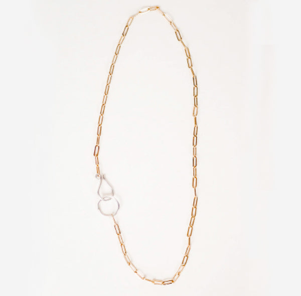 White backdrop with a delicate, 14k gold filled cable chain necklace.  Links are elongated and flat to pick up on extra sparkle.  Handmade sterling silver hook clasp is enlarged relative to the links for contrast and ease of use. 