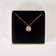 Close up of handcrafted textured 14k gold vermeil circle pendant necklace on black foam inside of a Krista Knickerbocker Designs jewelry box.