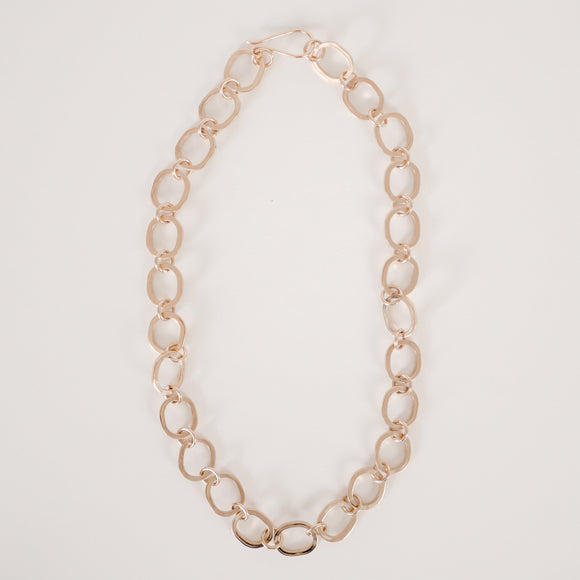 Gold chunky chain necklace with large cast oval links and small round connecting links on a white background.  Item is handmade by Krista Knickerbocker Designs.