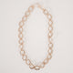 Gold chunky chain necklace with large cast oval links and small round connecting links on a white background.  Item is handmade by Krista Knickerbocker Designs.
