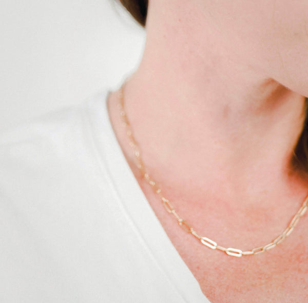 Close up of a woman's neck wearing Krista Knickerbocker Design's everyday 14k gold filled chain with elongated flat links.