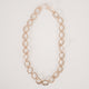Gold chunky chain necklace with large cast oval links and small round connecting links on a white background.  Item is handmade by Krista Knickerbocker Designs. 